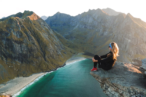 Hiking Woman sitting on cliff