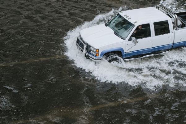 truck driving through flood