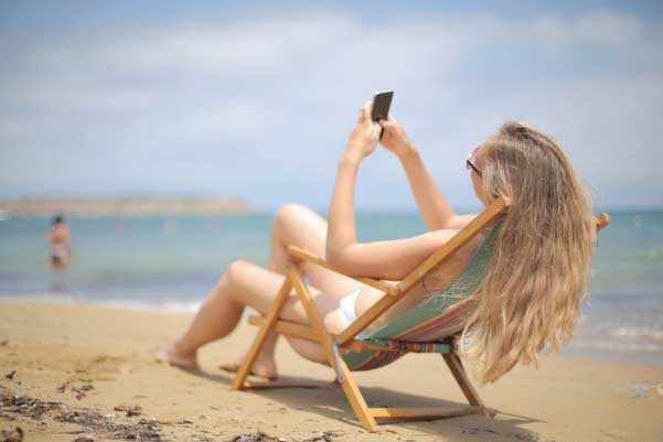 Lady on phone on beach