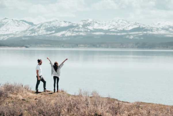 Couple infront of lake and mountains