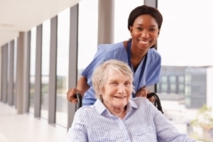 Senior in wheelchair with nurse