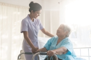 Senior with a walker with nurse