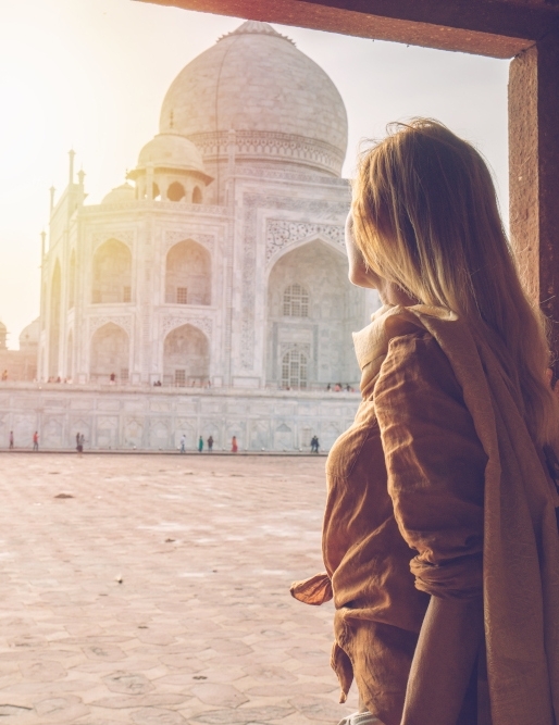 Beautiful blond hair girl contemplating sunrise at the Taj Mahal in India CAP study abroad student looking at the Taj Mahal