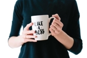 Woman holding a 'like a boss' mug