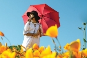 Woman in flower field with Umbrella